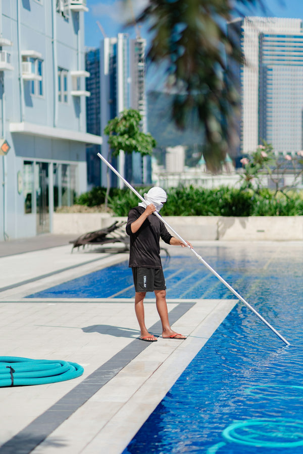 Skimming a swimming pool surface with a pole net